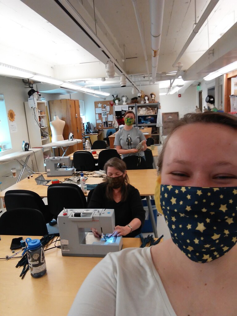 PLU Costume Designer Kathy Anderson has been working with students Lilian Oellerich (right) and Celeste Jessop (back) to create over 10 dozen masks to distribute to PLU students and essential staff.