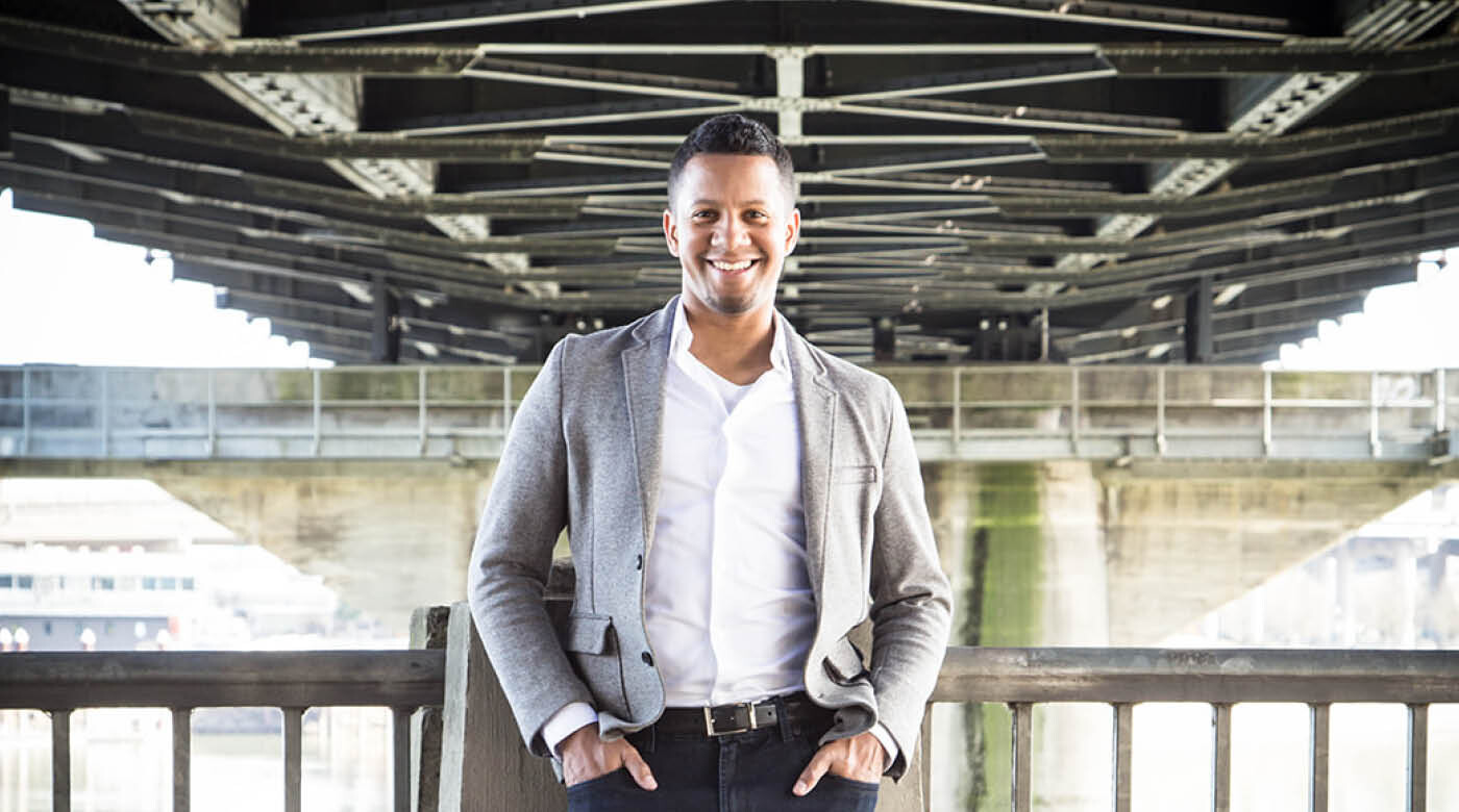 Jacob Taylor-Mosquera poses under a large bridge in Seattle