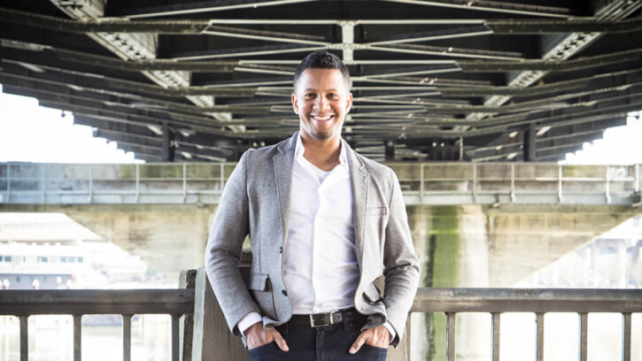 Jacob Taylor-Mosquera poses under a large bridge in Seattle