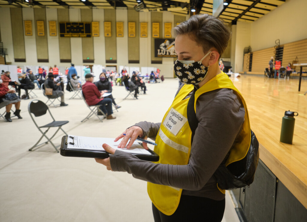 Cara Hall '20 working in her role as logistics coordinator for the Tacoma Pierce County Health Department at the Feb 11 vaccination event held at PLU.