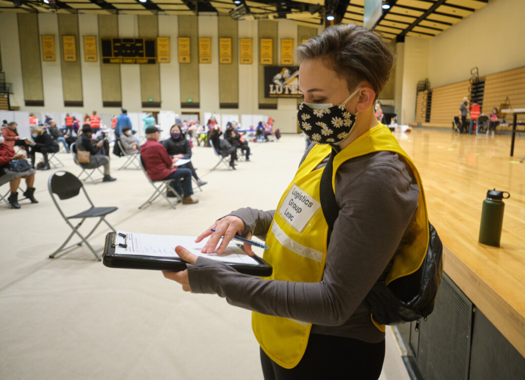 covid-vaccinations-2-11-21-826 Cara Hall '20 working in her role as logistics coordinator for the Tacoma Pierce County Health Department at the Feb 11 vaccination event held at PLU.
