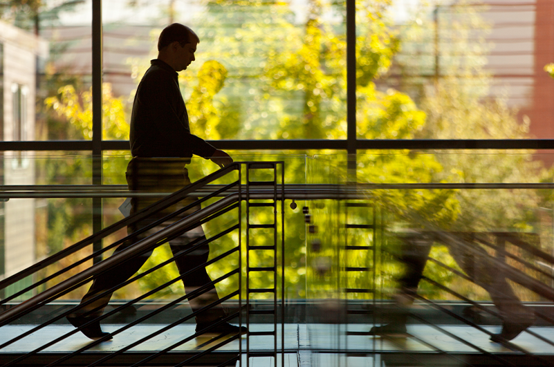 Silhouette of a person walking across the hallway in Morken center for learning and technology at PLU.