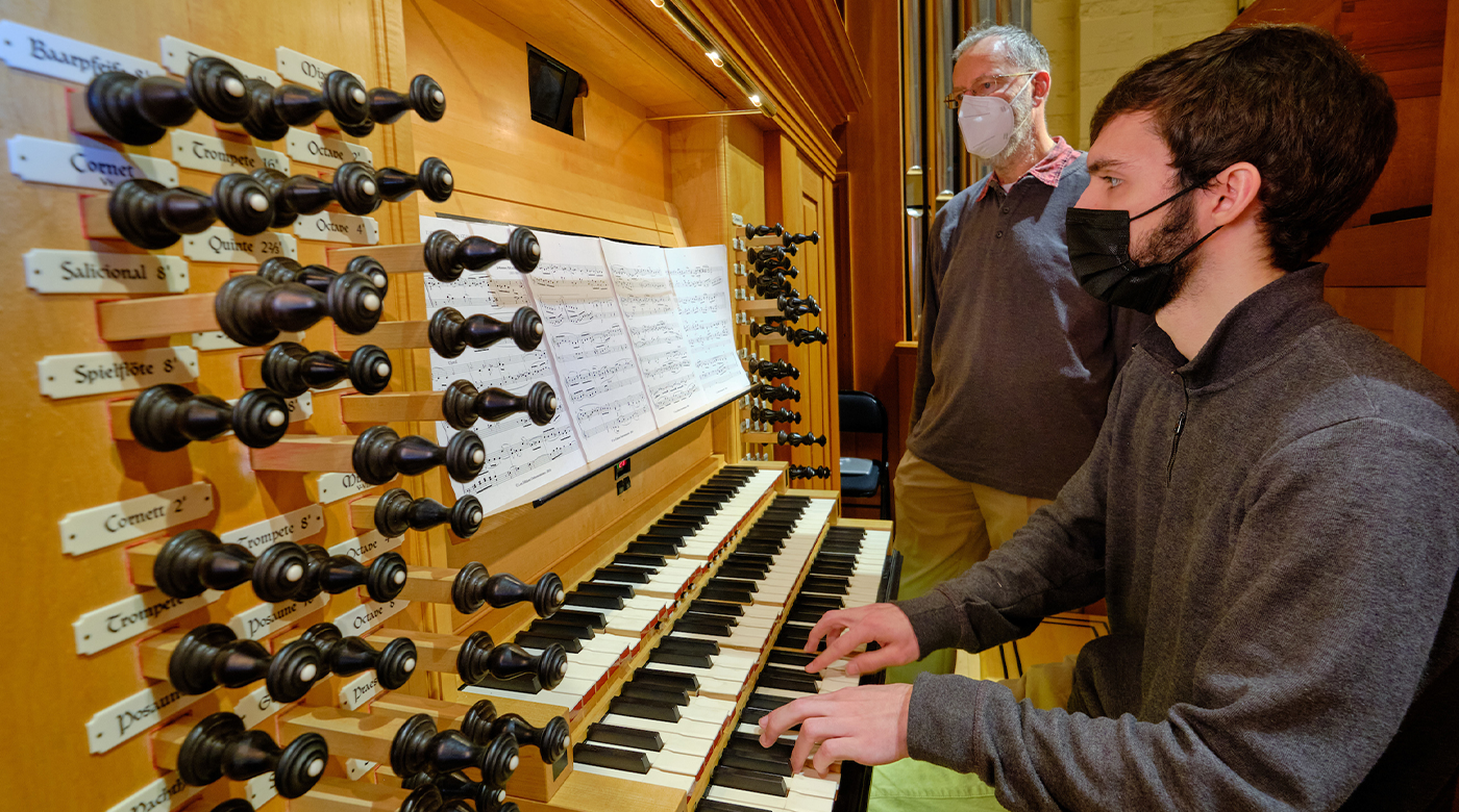 Associate Professor of Music - with a student playing on the organ.