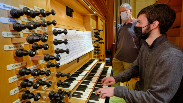 Associate Professor of Music - with a student playing on the organ.