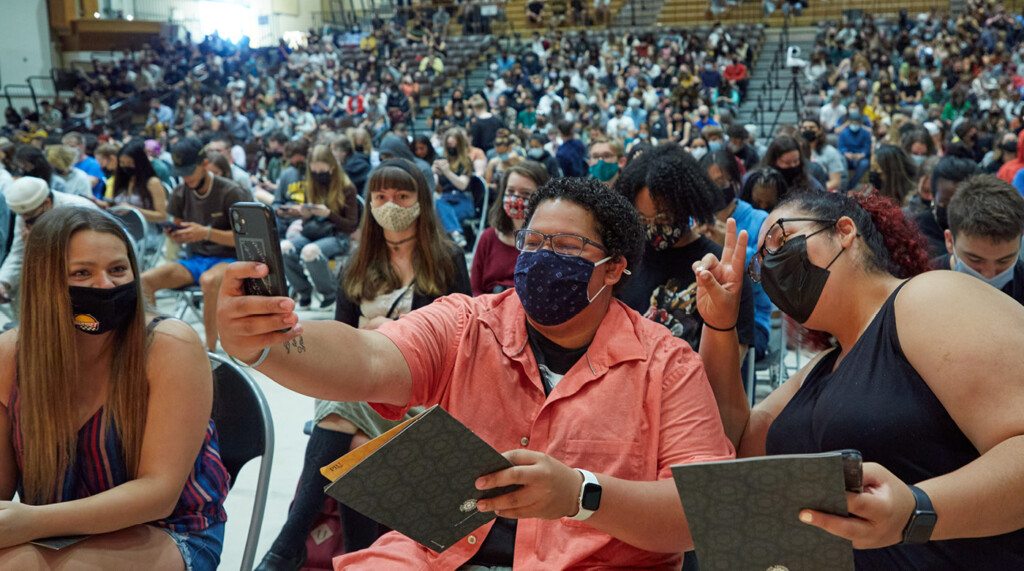 return-5 Lutes wearing protective masks take a selfie in the gym before the start of the convocation ceremony.