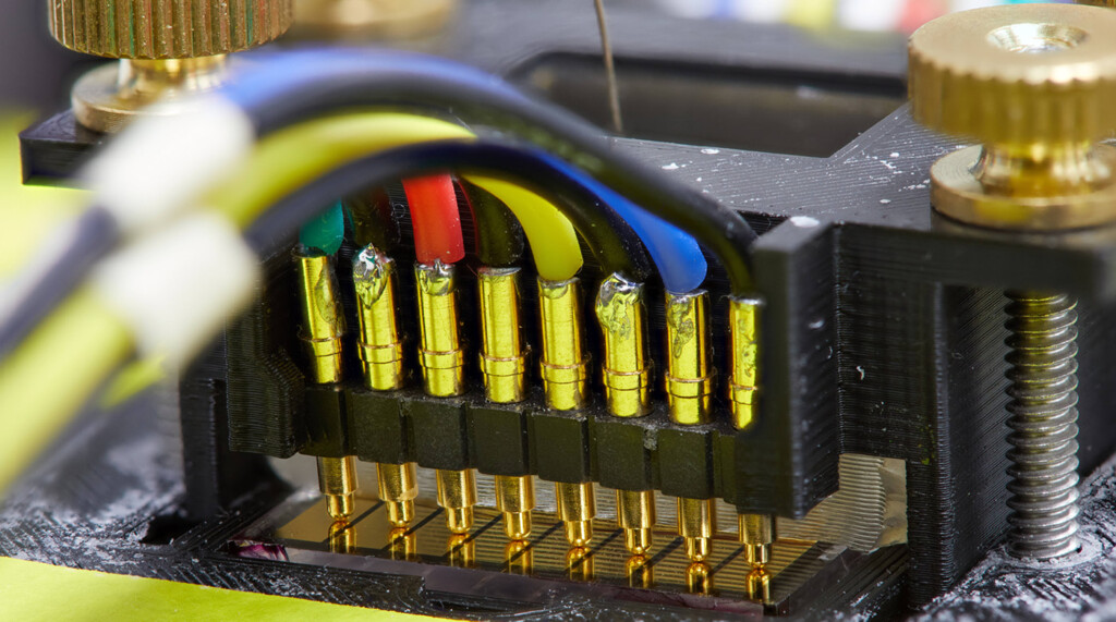 an electricity board with different color wires coming out of it