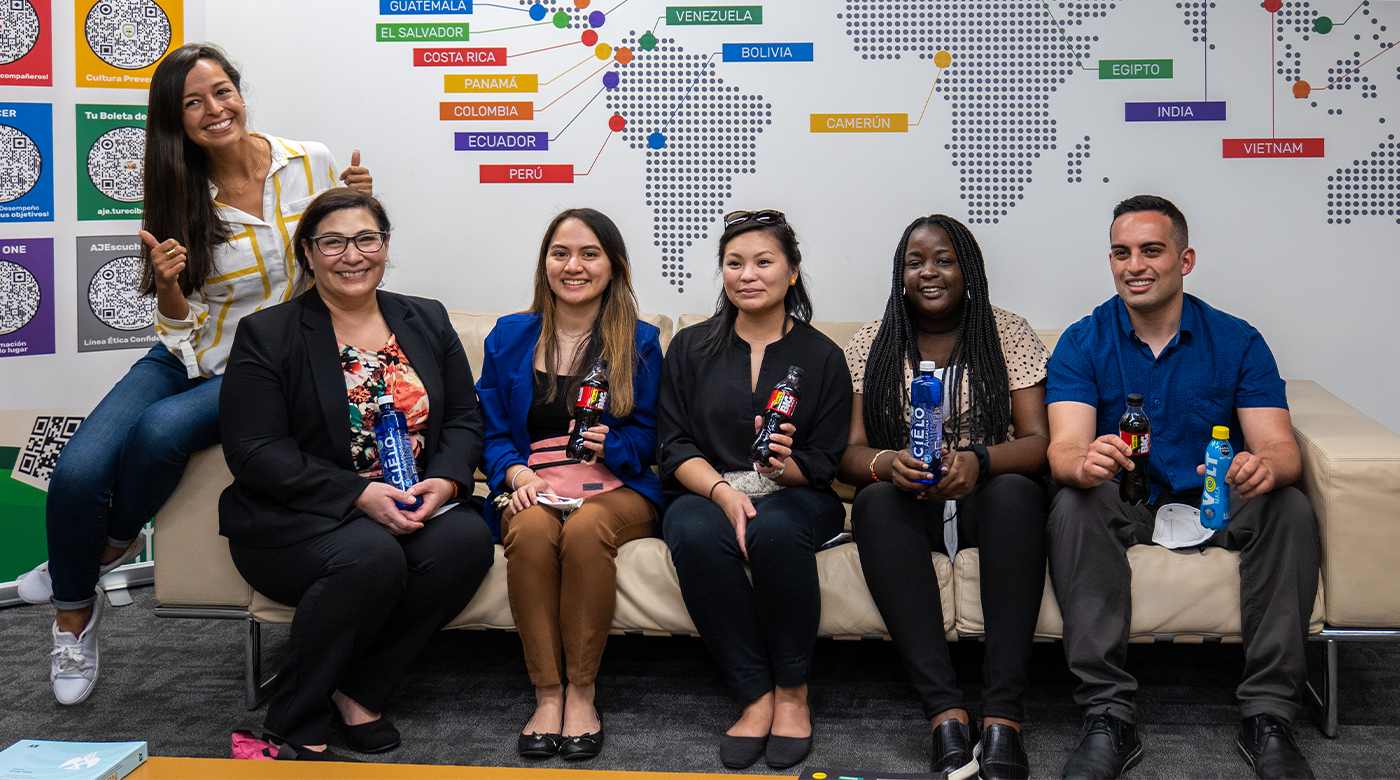 Photo of PLU MBA Students sitting on a couch at Peru's AJE Beverage Co.