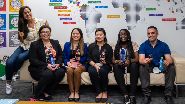 Photo of PLU MBA Students sitting on a couch at Peru's AJE Beverage Co.