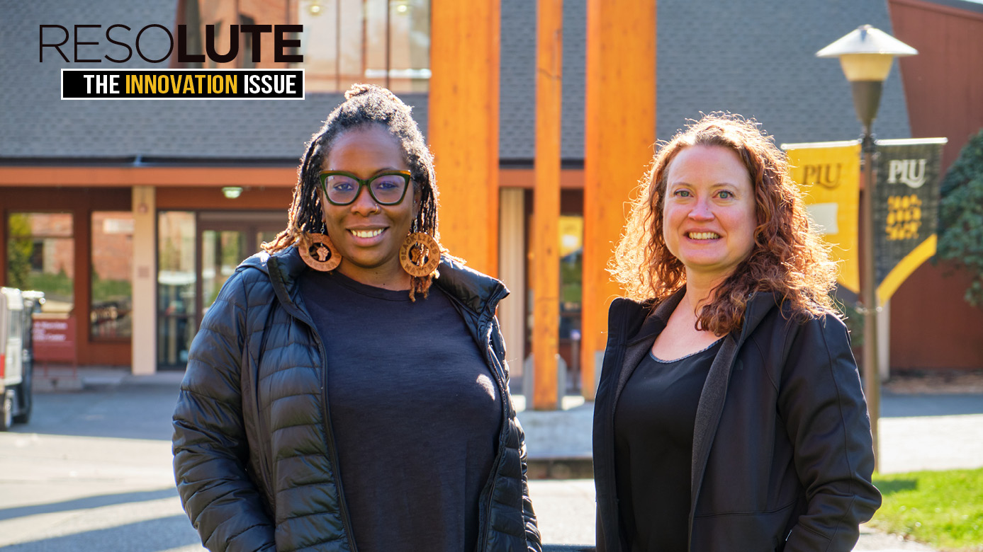 Jen Smith and Angie hambrick smile into the camera while standing outside the Anderson University Center.