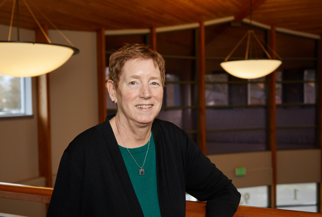 Teri Card smiles into the camera in the lobby of her office building.