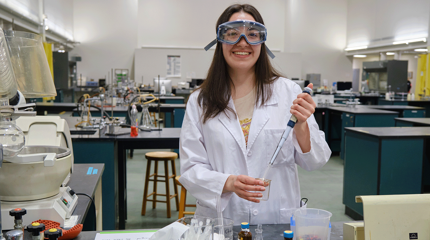 Yaquelin Ramirez Ferrer '22, poses in the second floor lab where as a chemistry major she spent much of her time, Monday, April 18, 2022, at PLU (PLU Photo/John Froschauer)
