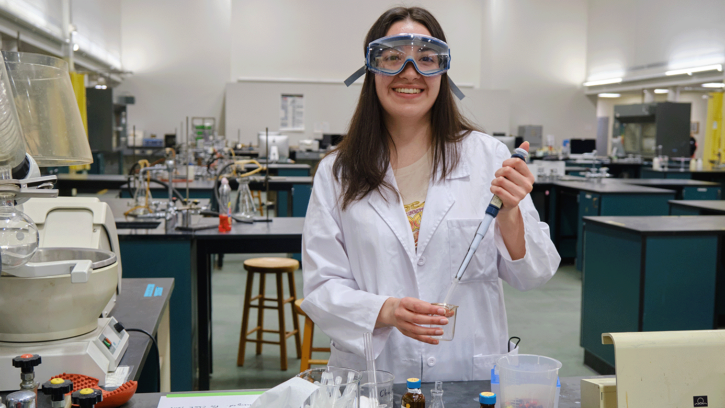 Yaquelin Ramirez Ferrer '22, poses in the second floor lab where as a chemistry major she spent much of her time, Monday, April 18, 2022, at PLU (PLU Photo/John Froschauer)