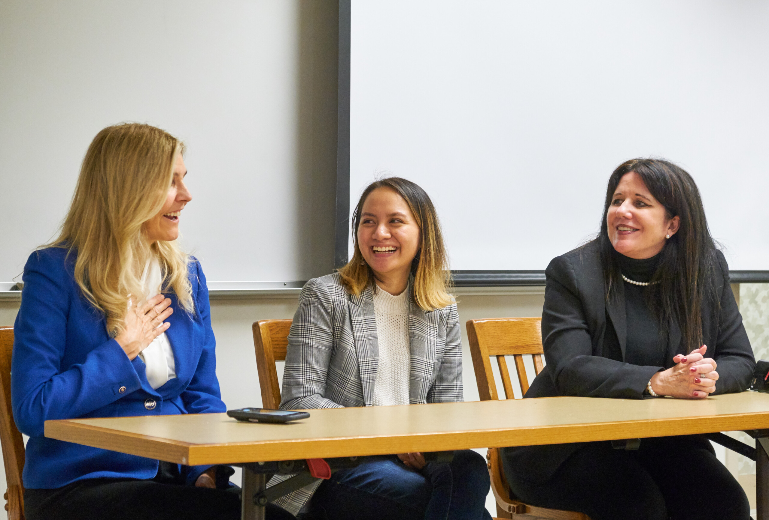 April Rose sitting in the middle of two panelists at her undergraduate capstone presentation in 2019.