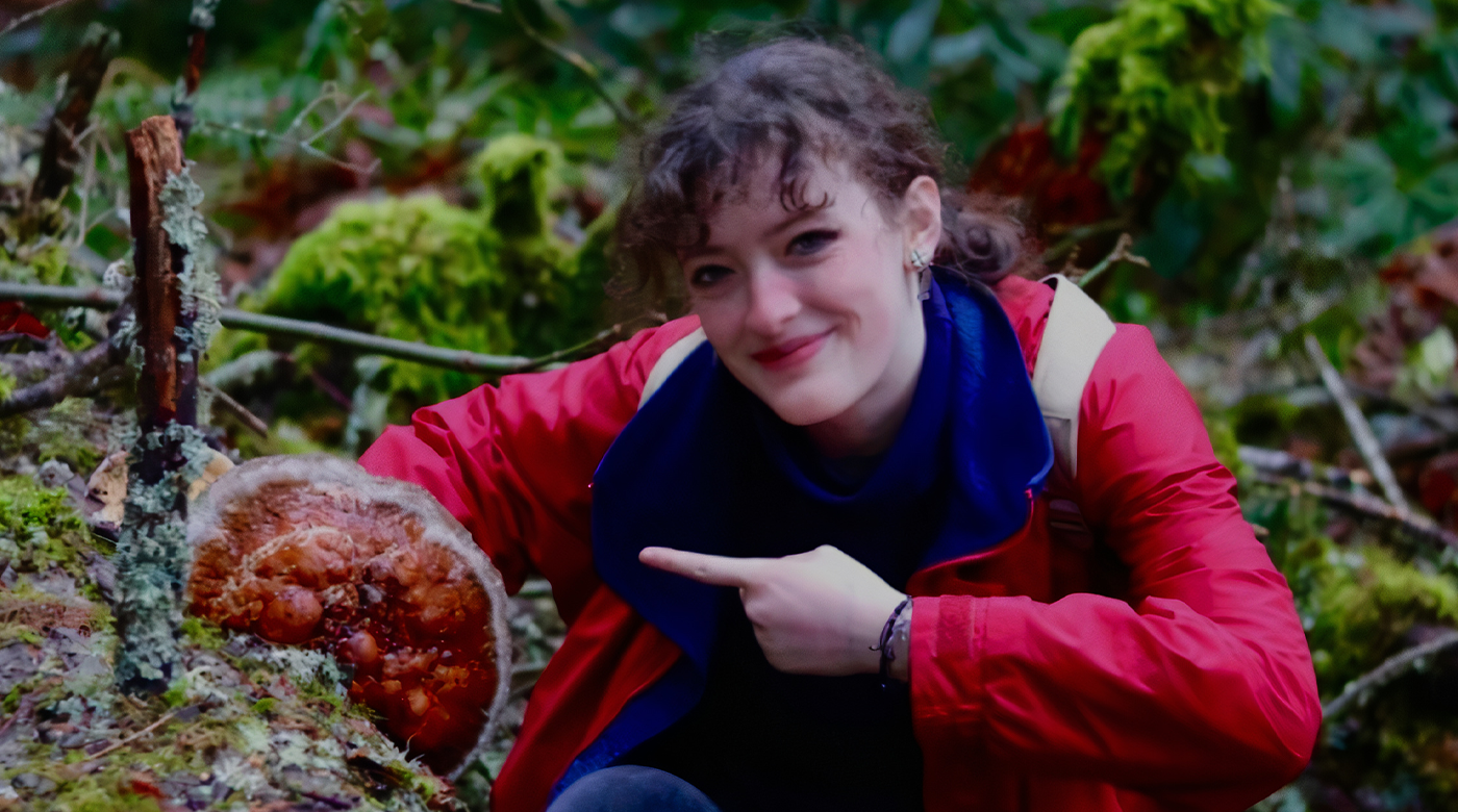 Environmental Studies Major Fiona Ashton-Knochel ’24 poses and points at a tree during her summer internship