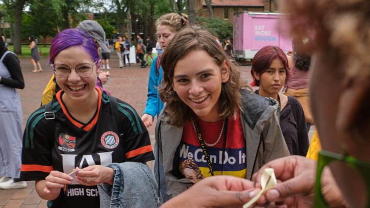 Two incoming Lutes smile and laugh as they do a craft at the engagement fair at New Student Orientation.