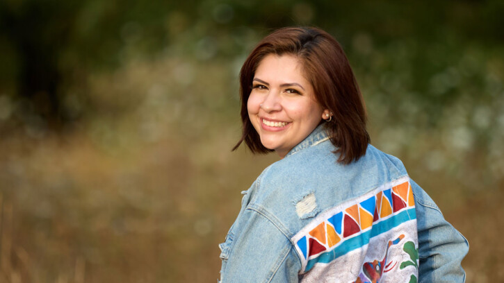 Elizabeth Larios photographed in a biology lab as a field by Morken and Rieke with a jacket she had made in Namibia where she has a Fulbright scholarship starting in January 2023, Thursday, Aug. 18, 2022, at PLU. (PLU Photo/John Froschauer)