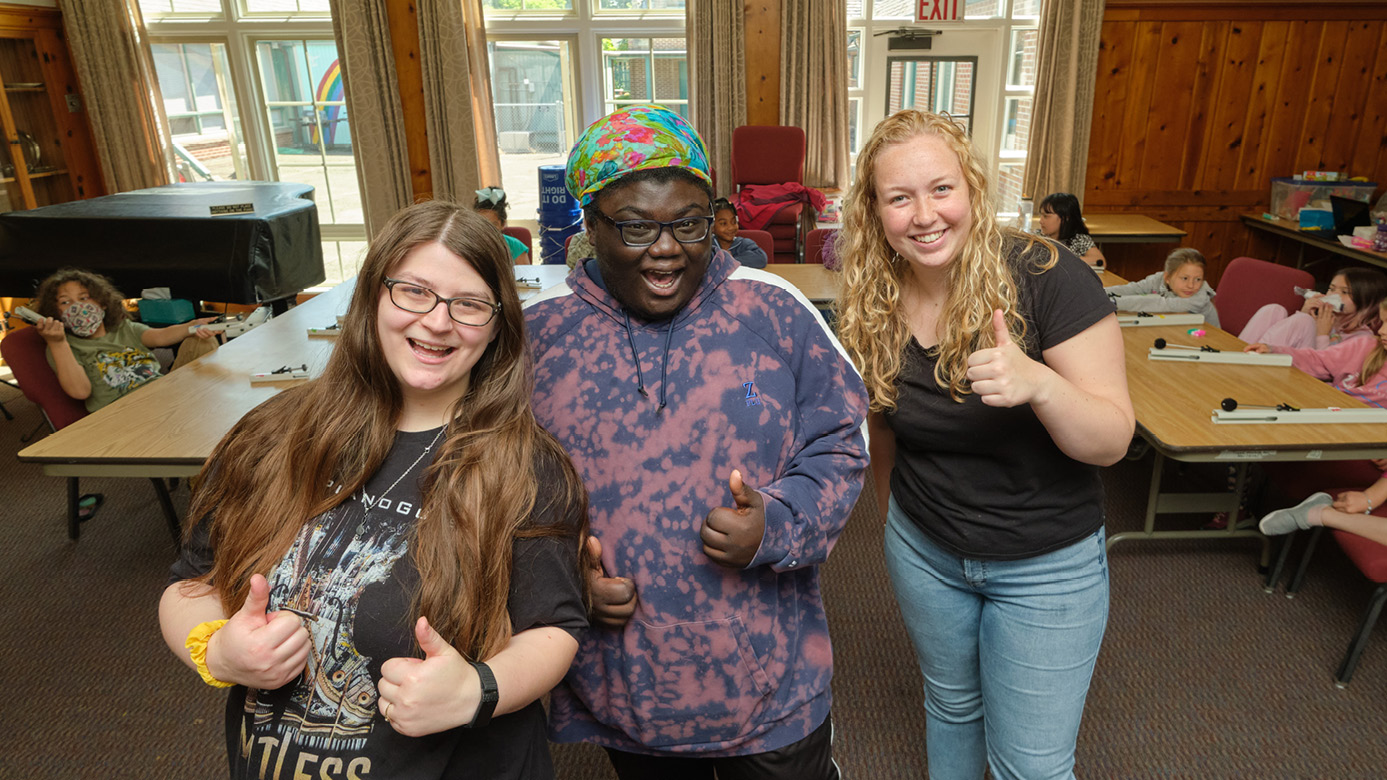 Kaila Harris ’24 (left), Zyreal Oliver-Chandler ’25 (middle) and Madison Ely ’23 (right) give an enthusiastic thumbs up during AMP Camp.