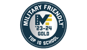 Image depicts a dark blue circular ribbon with a white center. Against the dark blue, white text in all caps reads "Military Friendly Top 10 School." In the center is the dark blue and gold logo for Military Friendly, a letter M and F blending into each other, along with "'23-24 Gold."