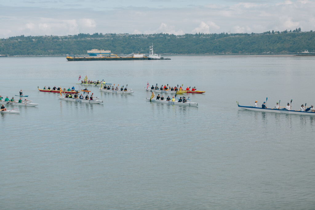 The Polynesian voyaging canoe Hōkūleʻa is escorted into Commencement Bay by puyallup tribe canoes.