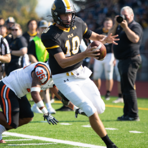 Erik Bainter Football player running with the ball during a game.