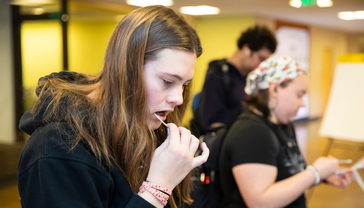 800be the match event A student swabs their cheek at the PLU Be the Match event.