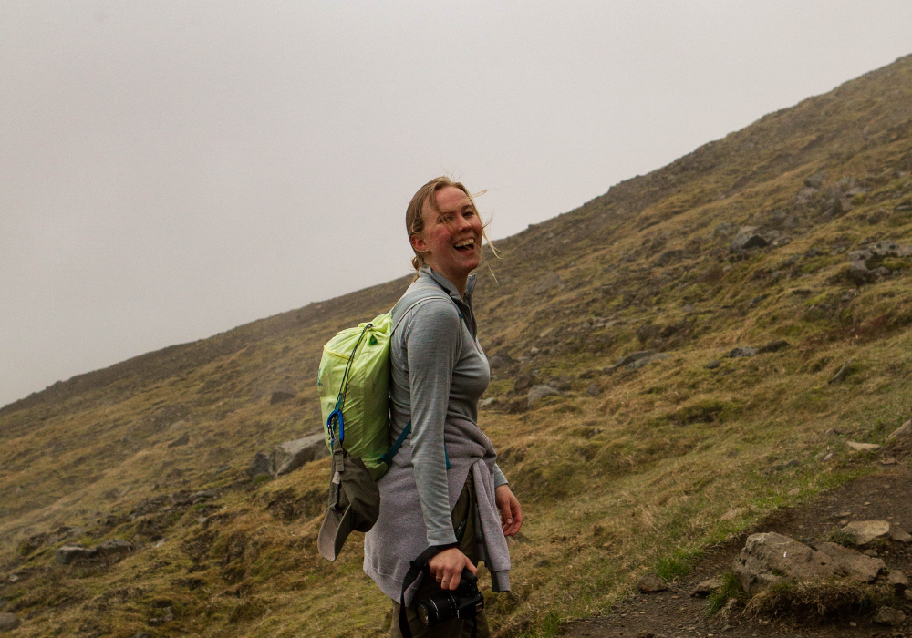 Iceland 1 Student looks into the camera and smiles as they hike up Mt. Esja.