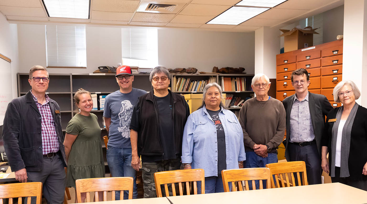 PLU and Nisqually leaders stand in a meeting room in PLU's Xavier hall.