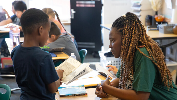 Eva Dumeni, a teacher from Namibia, works with a student in Brianna Wells' class at Clover Creek Elementary School in Pierce County, Washington.