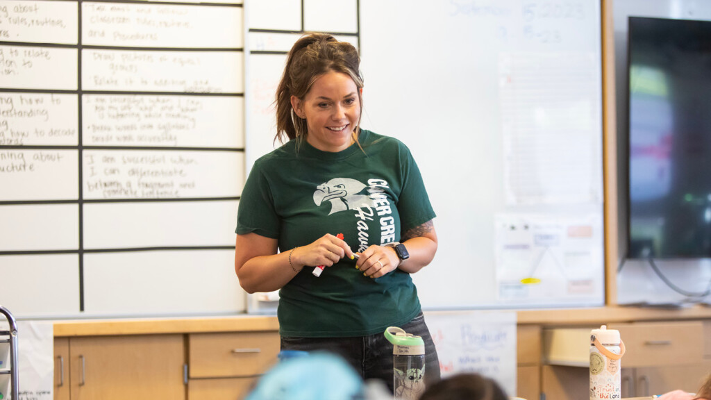 Brianna Wells stands in the front of a third grade class at Clover Creek Elementary.