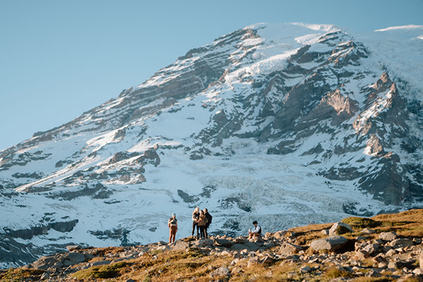 PLU students visiting Mt. Rainier on a clear day.