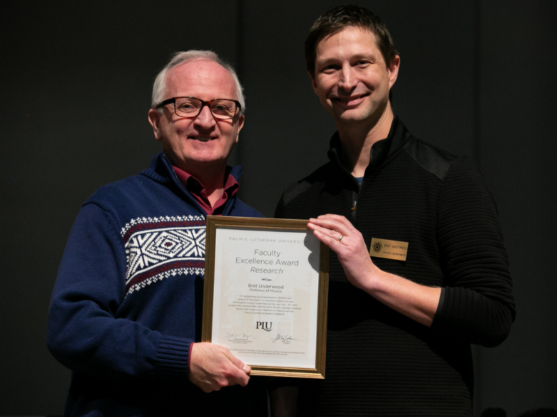 University President Allan Belton (left) presents Dr. Bret Underwood (right) with the 2023 K.T. Tang Faculty Excellence Award in Research.