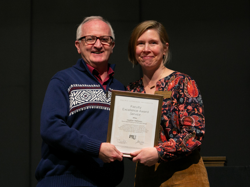 University President Allan Belton (left) presents Dr. Heather Mathews (right) with the 2023 Faculty Excellence Award in Service.