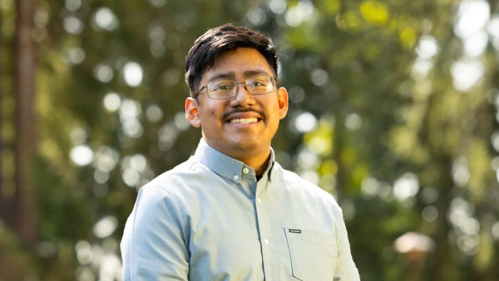 Senior graphic design major Guillermo Baltazar-Munoz poses for a portrait, Thursday, April 24, 2025, outside Ingram Hall at PLU. (PLU Photo / Sy Bean)