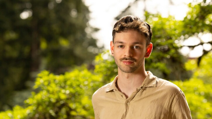 Ivan Wilson, Art Director for the student run creative agency Impact, poses for his senior spotlight portrait, Tuesday, May 6, 2025, outside the AUC at PLU. (PLU Photo / Sy Bean)