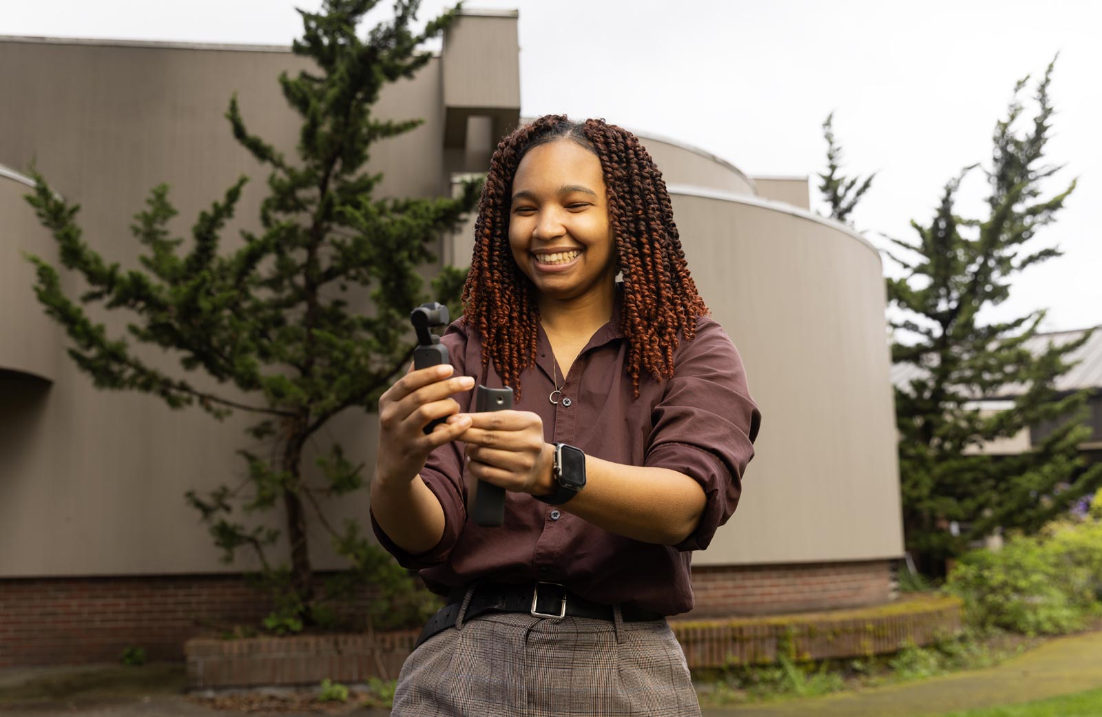 Zari Warden, a double major in Communication and Gender, Sexuality, and Race Studies, poses for a portrait, Tuesday, April 29, 2025, outside Ingram Hall at PLU. (PLU Photo / Sy Bean)