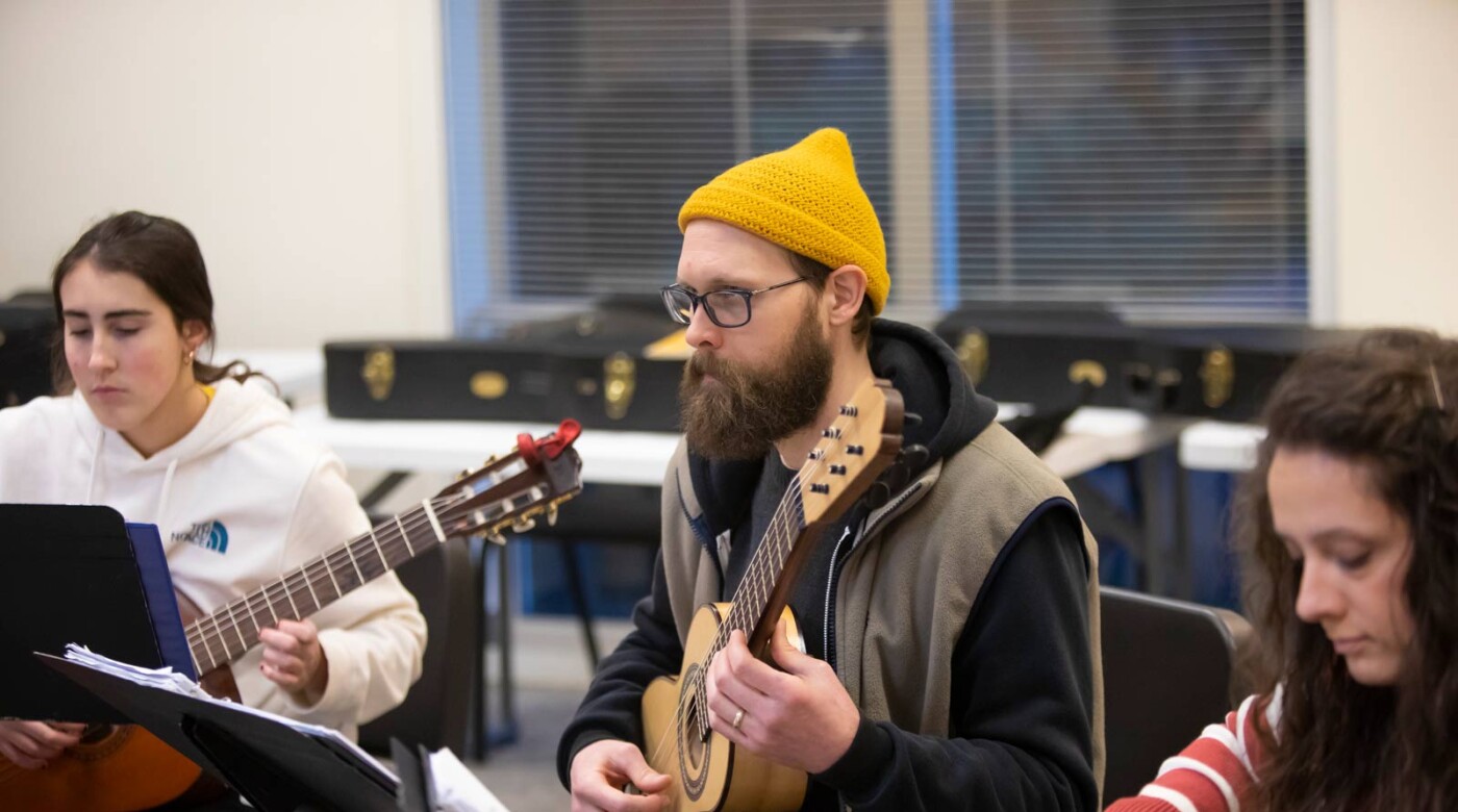Lecturer Elizabeth Brown leads a guitar ensemble lesson in MBR, Thursday, Feb. 23, 2023, at PLU. (PLU Photo / Sy Bean)