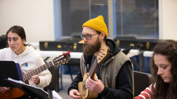 Lecturer Elizabeth Brown leads a guitar ensemble lesson in MBR, Thursday, Feb. 23, 2023, at PLU. (PLU Photo / Sy Bean)