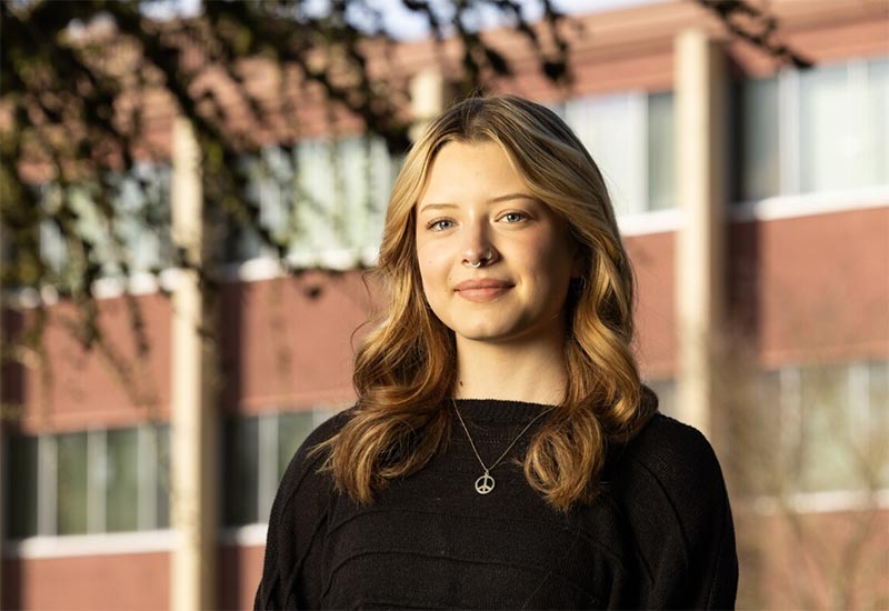 Gracie Hansen '25 standing and smiling