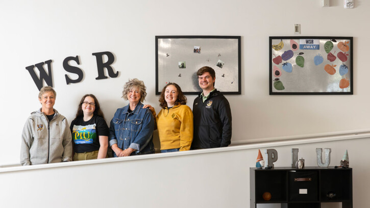 Wellness Services and Resources staff members standing in front of a wall (PLU Photo / Sy Bean)