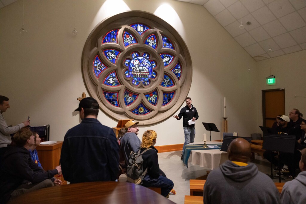 20251004_SB_HFW_1859-full Chris Staudinger stands in front of PLU's rose window and facilitates a tour inside of PLU's Ness Family Chapel during Homecoming & Family Week at PLU.