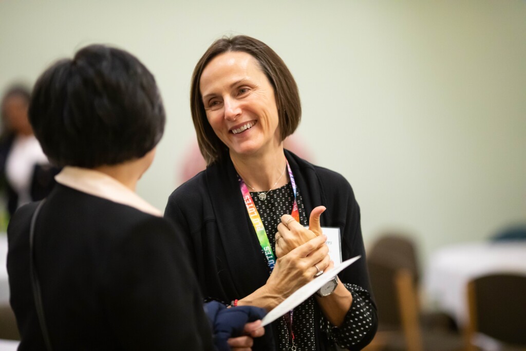 Anissa Rogers, chair of PLU's Master of Social Work program, smiles at a colleague during a departmental event on campus.