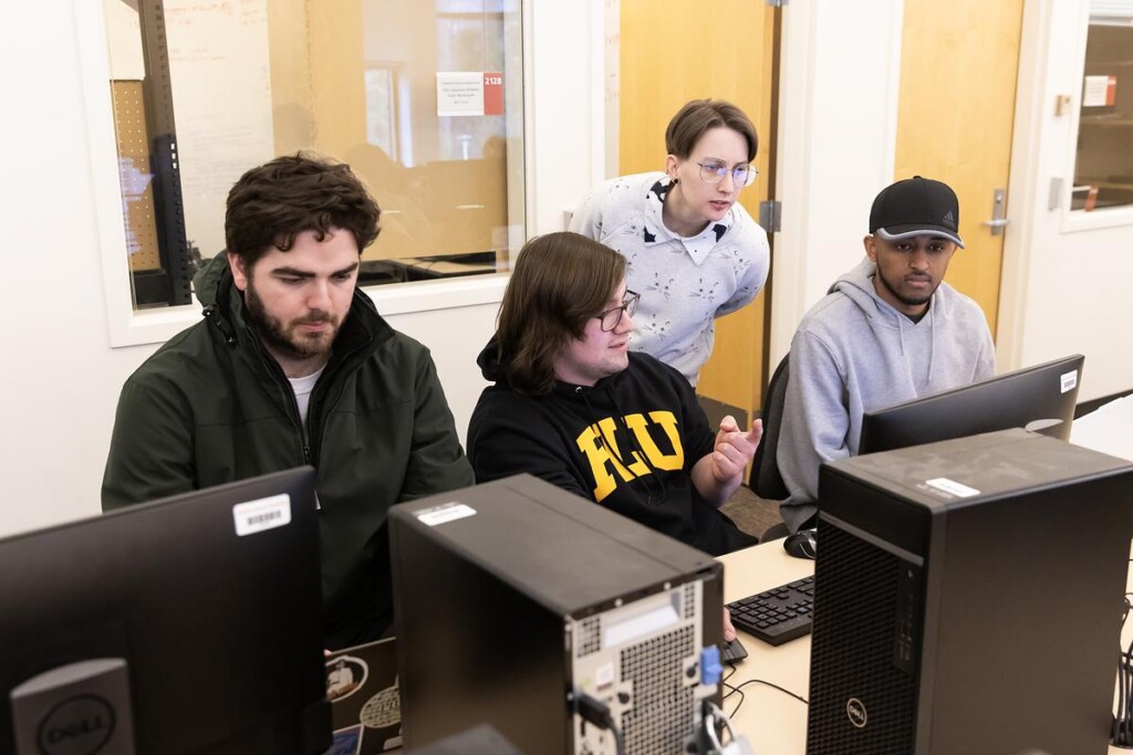 20250314_SB_CSCI-488_013-medium Assistant Professor Alexandra Bacula assists students in operating software to control the modified Roomba robot in “Special Topics in Computer Science: Programming for Robots" course.