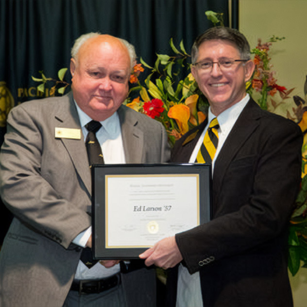 Ed Larson '57, accepts the Heritage Award from President Thomas Krise during the Awards Banquet September 29, 2012.
