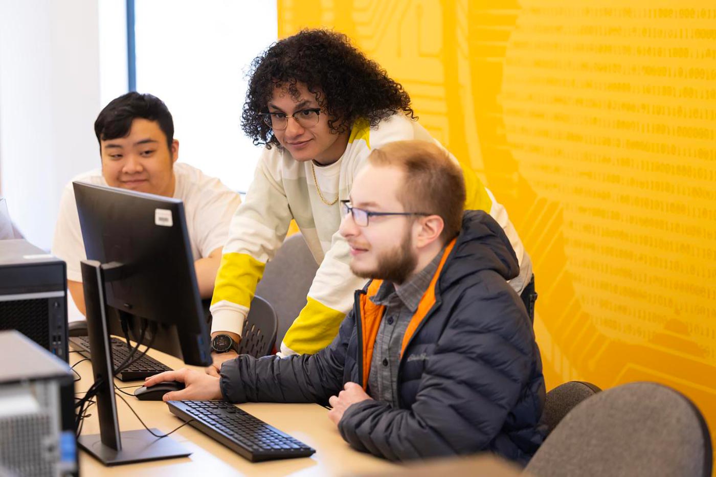 Assistant Professor Alexandra Bacula assists students in operating software to control the modified Roomba robot in CSCI 488, titled “Special Topics in Computer Science: Programming for Robots,” Friday, March 14, 2025, in the Morken Center for Learning and Technology at PLU. (PLU Photo / Sy Bean)