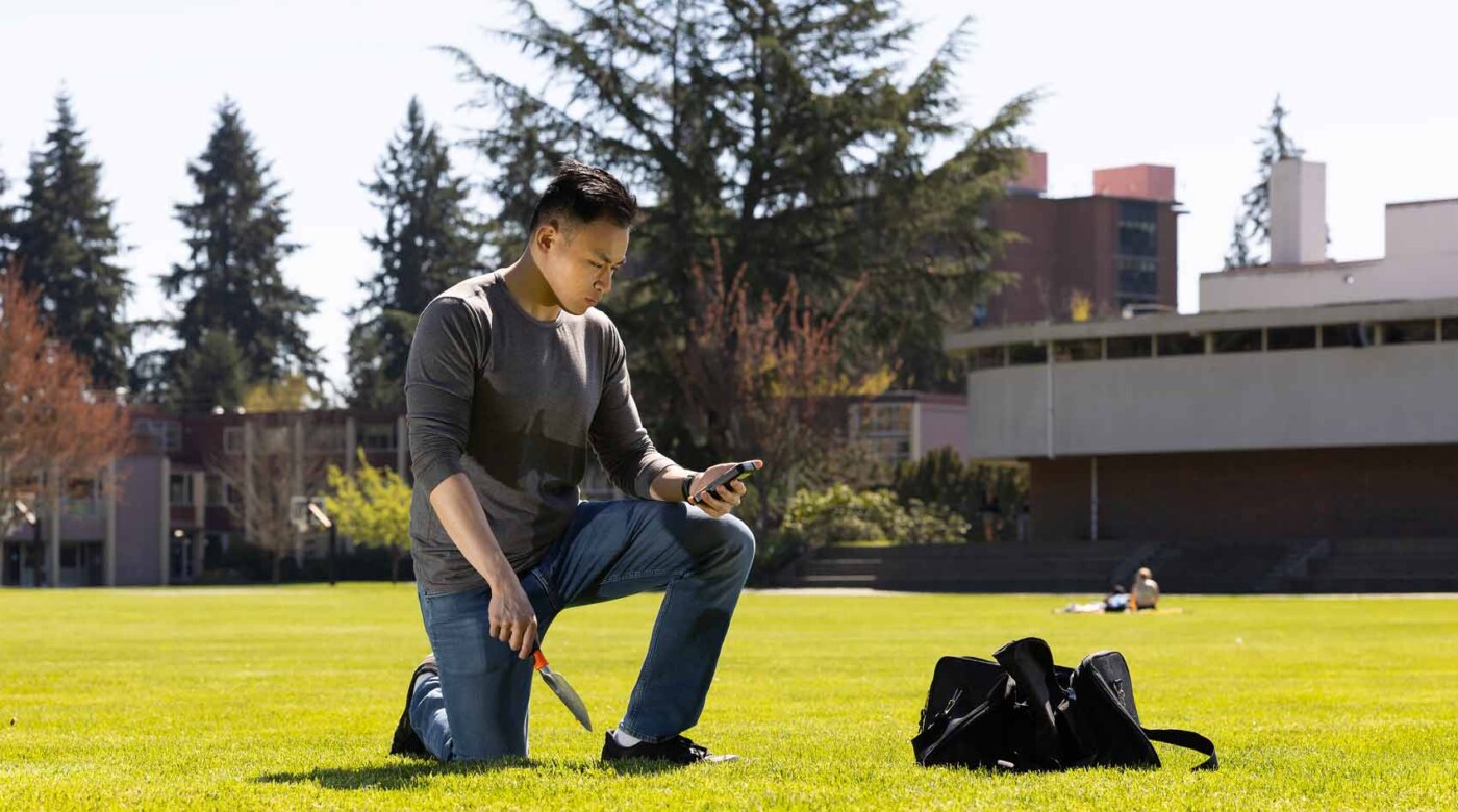 Vincent collects soil samples on PLU’s campus for his capstone project comparing radiation levels here to levels near Mount St. Helens.