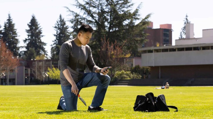 Vincent collects soil samples on PLU’s campus for his capstone project comparing radiation levels here to levels near Mount St. Helens.