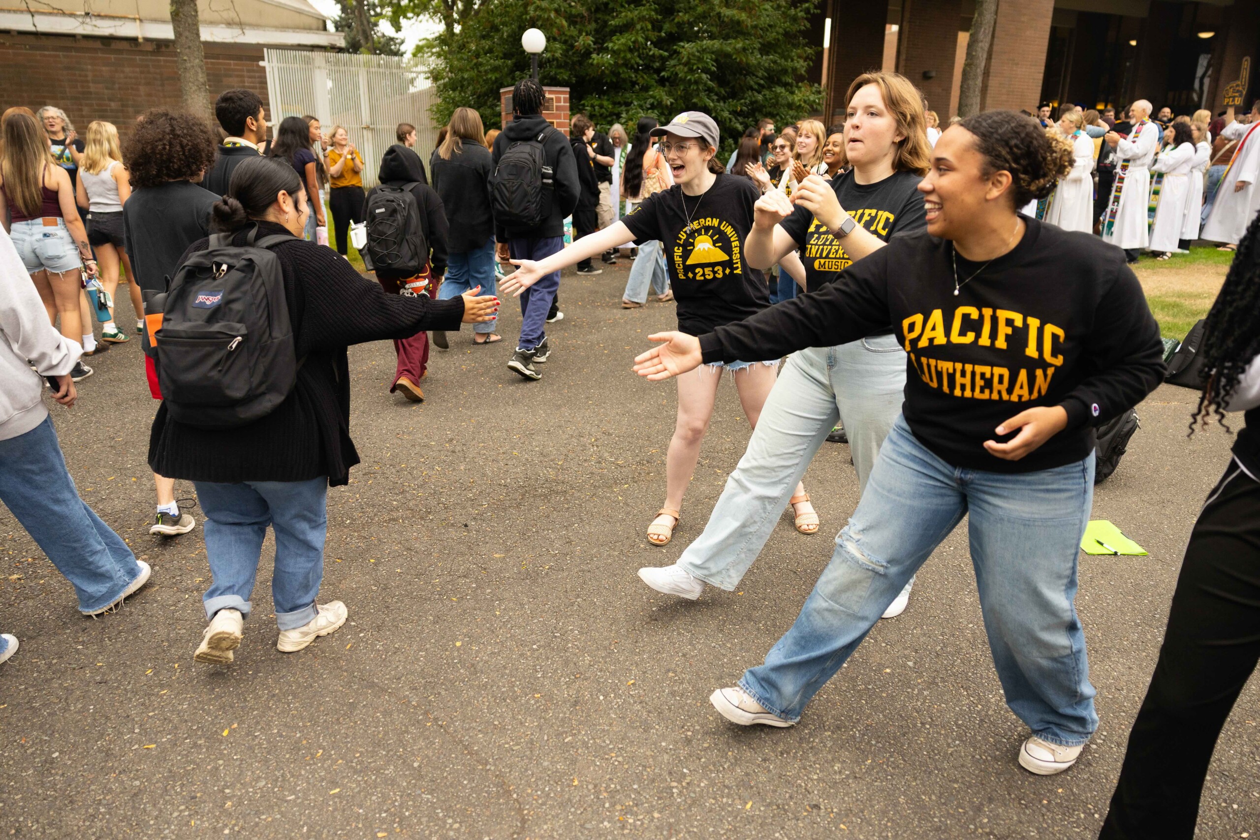 20250902_SB_Convocation_063-full A crowd of students high five staff and faculty PLU's traditional Convocation event on campus.
