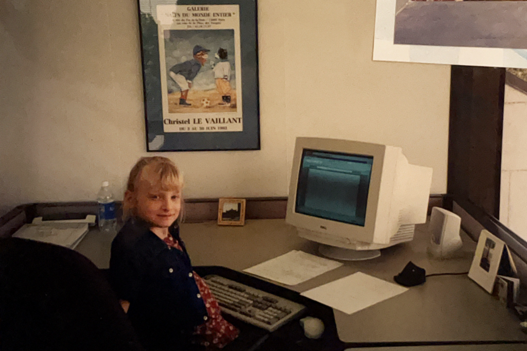 Photo of Courtney as a child in front of her mother's computer.