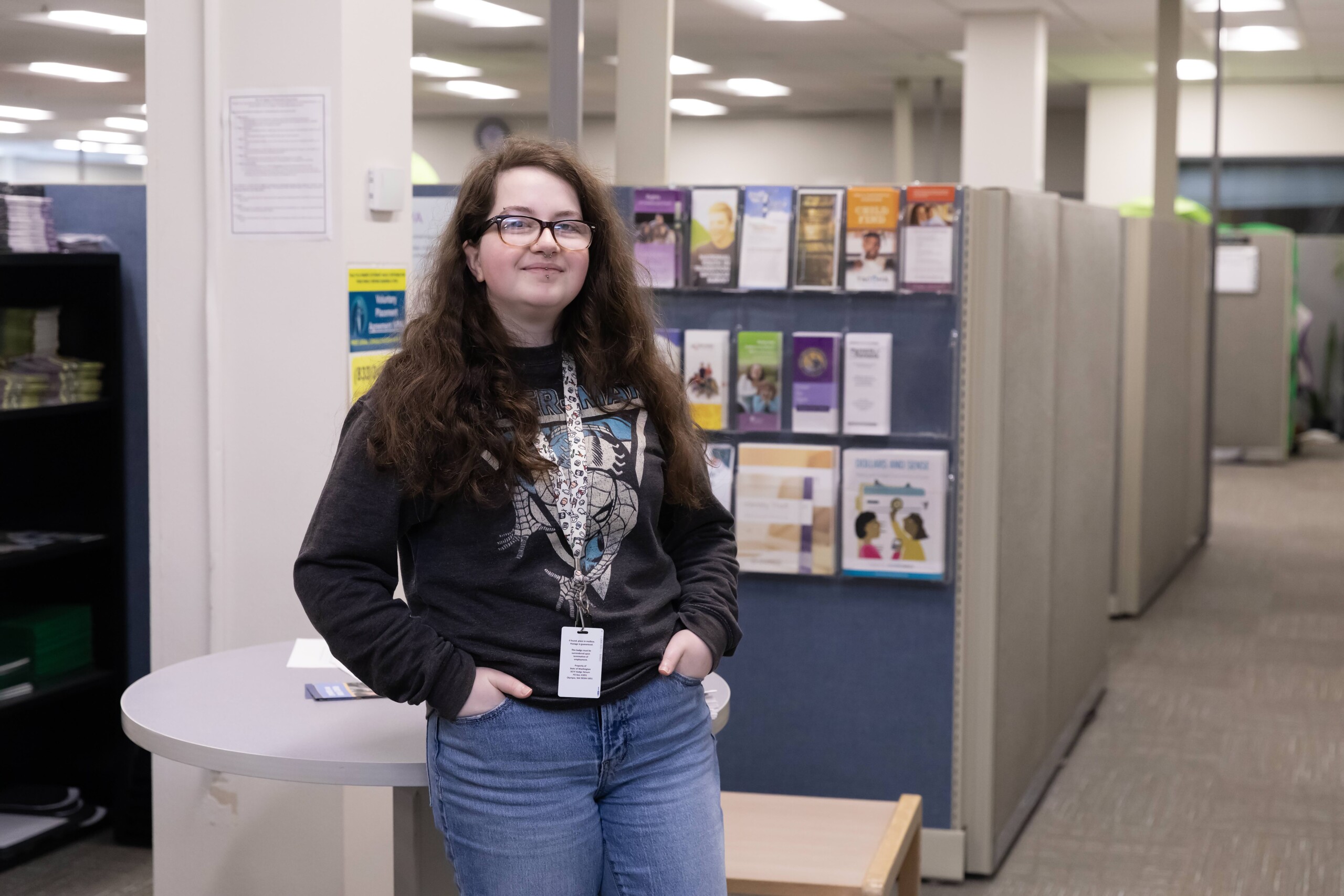 20240403_SB_SOCW-Placement_281 A young woman wearing glasses stands in an office setting.