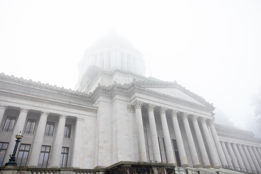 Neoclassical government building with dome shrouded in fog and mist